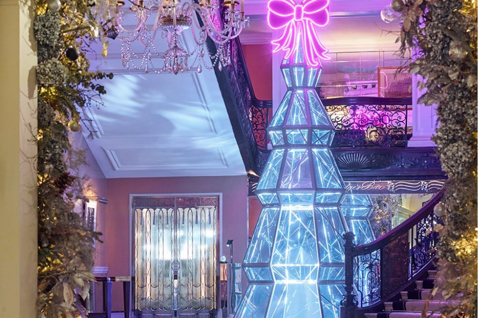 Claridge’s famous designer Christmas tree sparkling in the marble lobby, defining luxury at the best hotels for London Christmas
