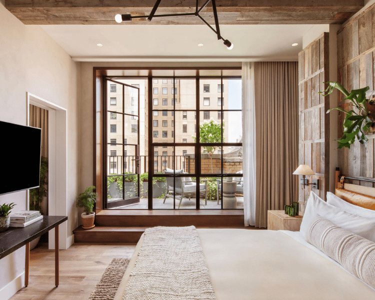 1 Hotel Central Park lobby filled with warm lights and natural decor, one of the most sustainable New York City Christmas Hotels.
