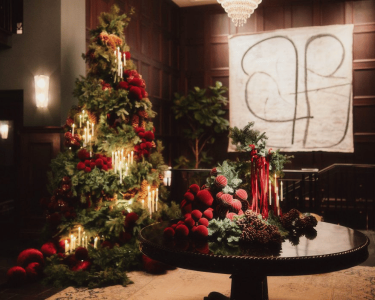 The Ned NoMad glowing with twinkling lights and festive decor, a trendy favorite among New York City Christmas Hotels