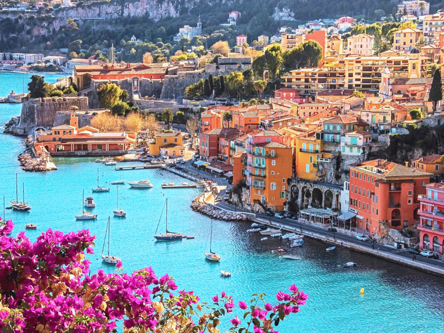 Pastel waterfront and sandy beach in Villefranche-sur-Mer, one of the best places to visit in the South of France