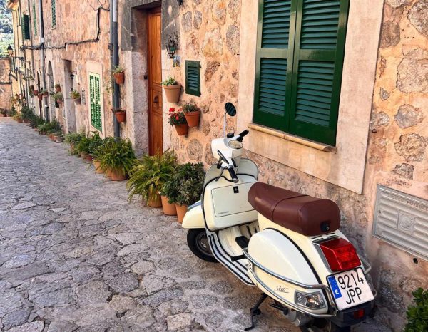 2 mallorca travel guide a moped parked on the street of valledmossa, a town to visit in this mallorca travel guide