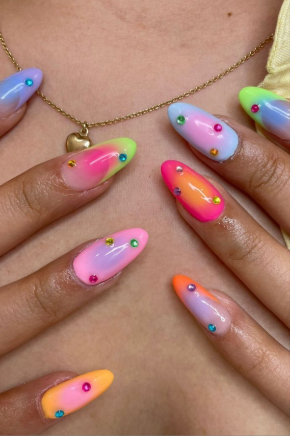 neon cat eye manicure with rhinestone accents perfect for festival nail ideas